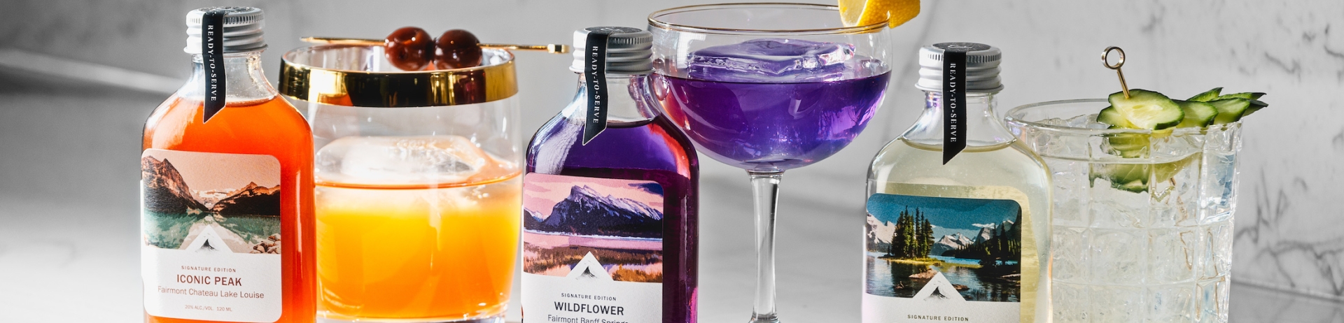 bottles of alcohol and cocktails sit on table