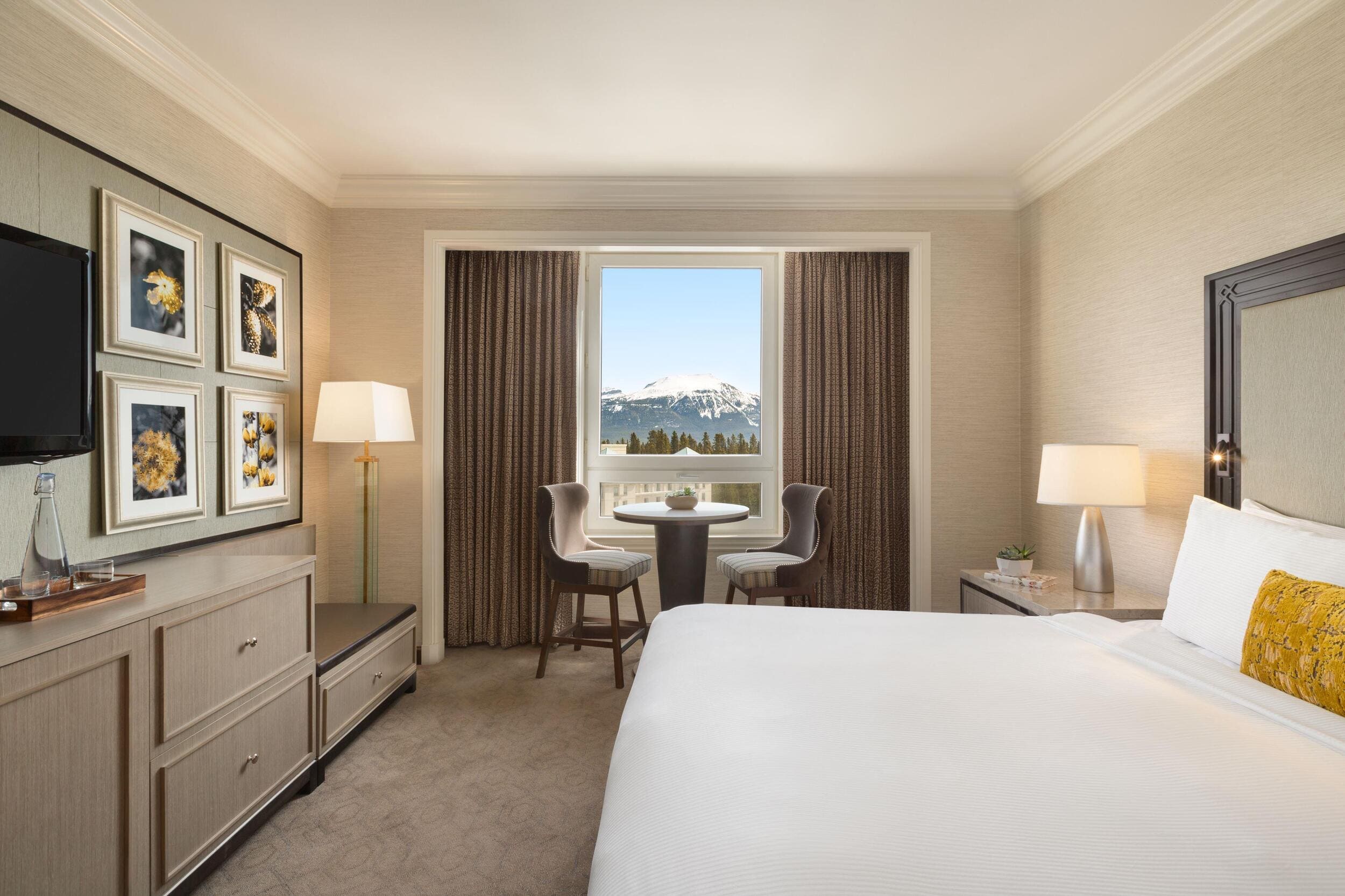 fairmont gold bedroom with a little table with two chairs