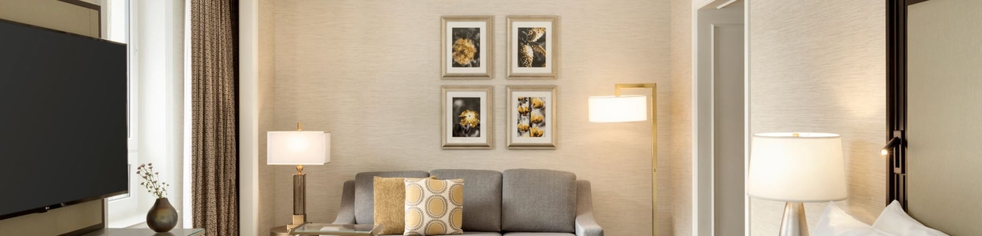 bedroom with a small sectional and four photos on the wall