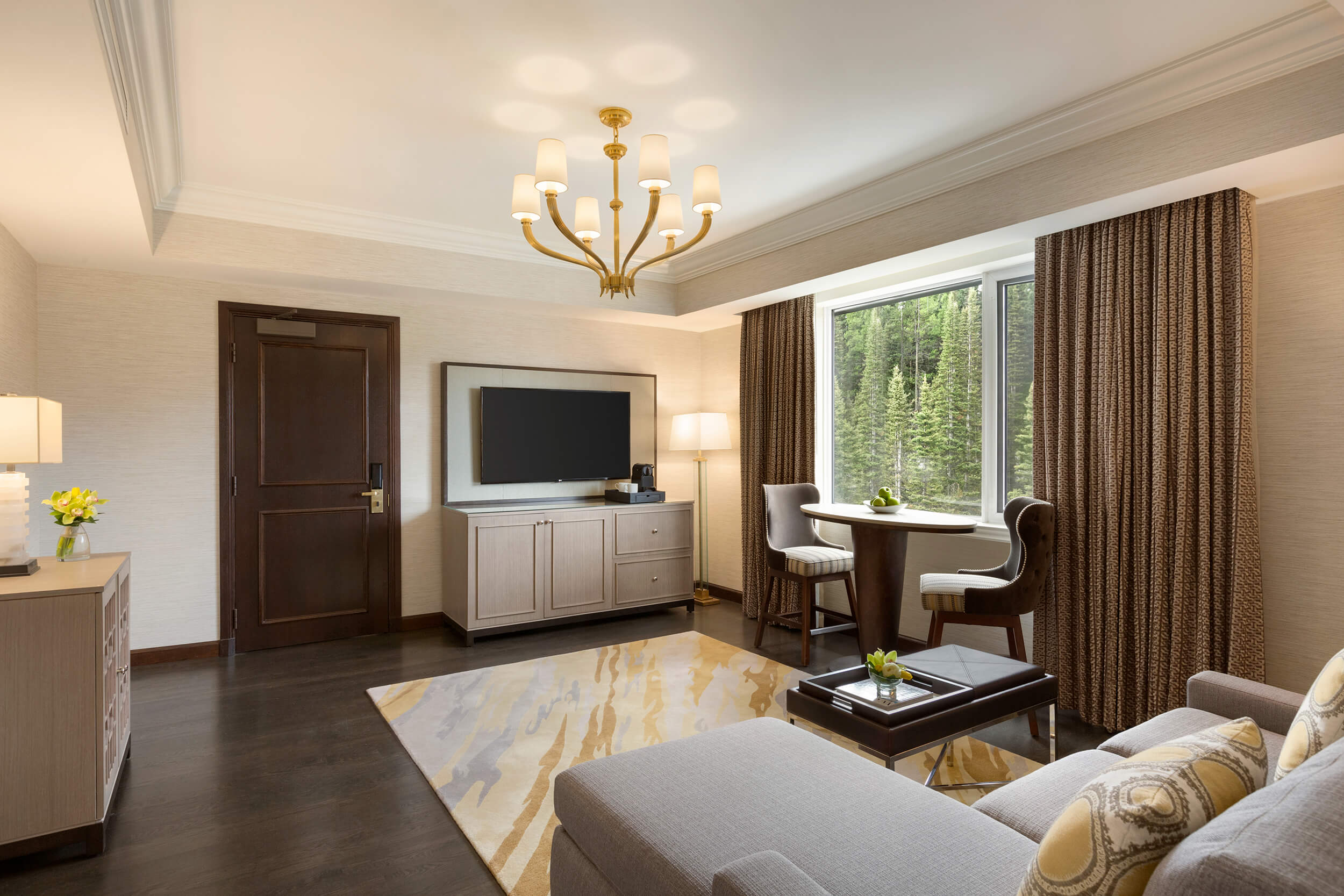 living room with small dining area overlooking the forest