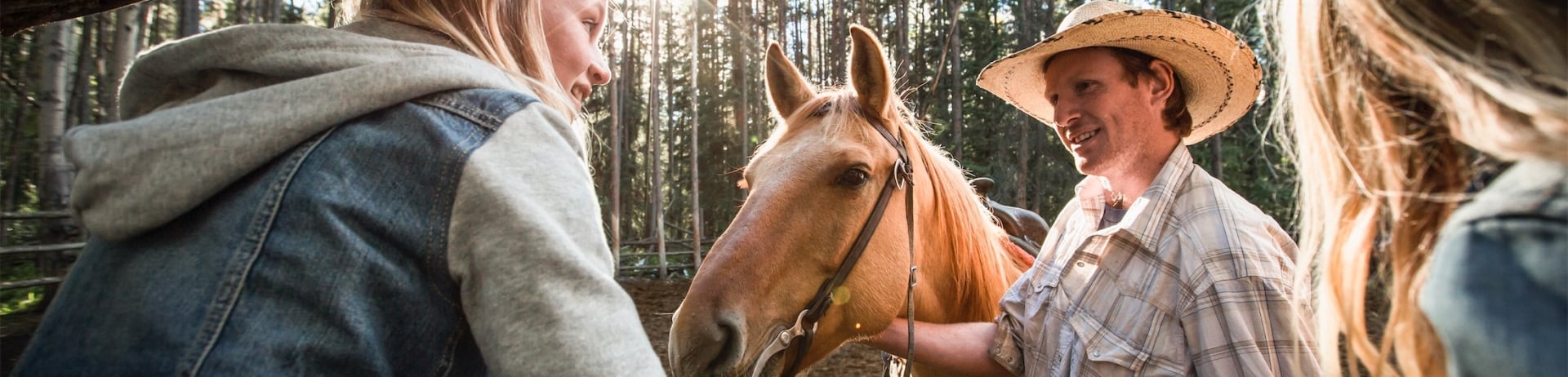 an instructor with a horse talking to kids