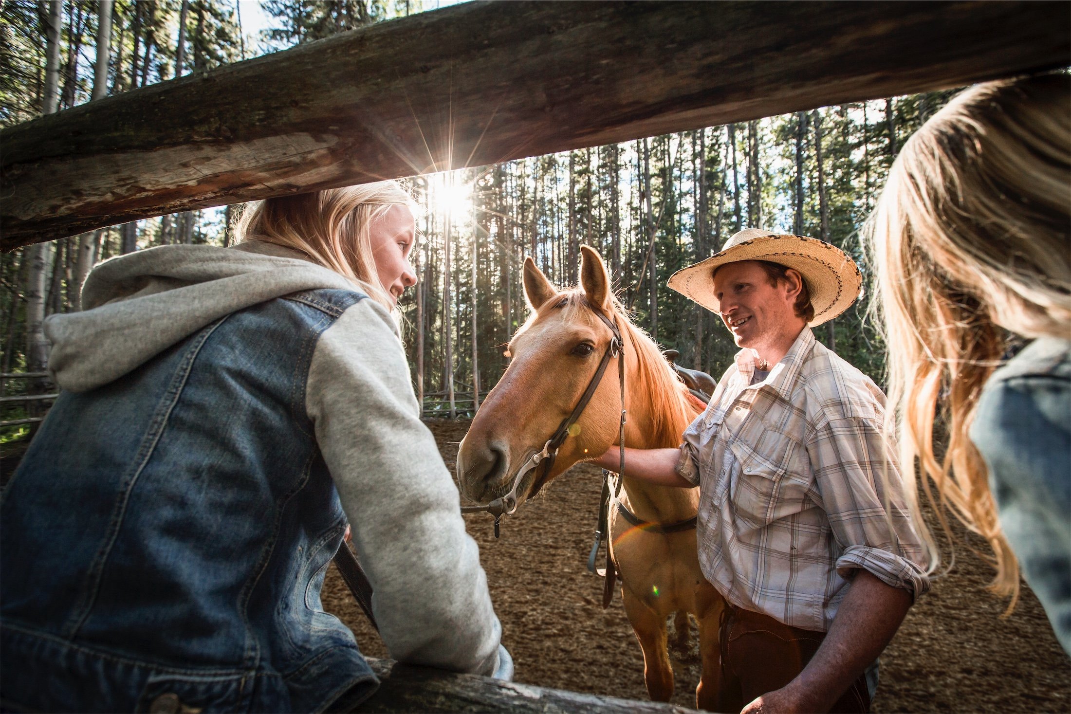 an instructor with a horse talking to kids