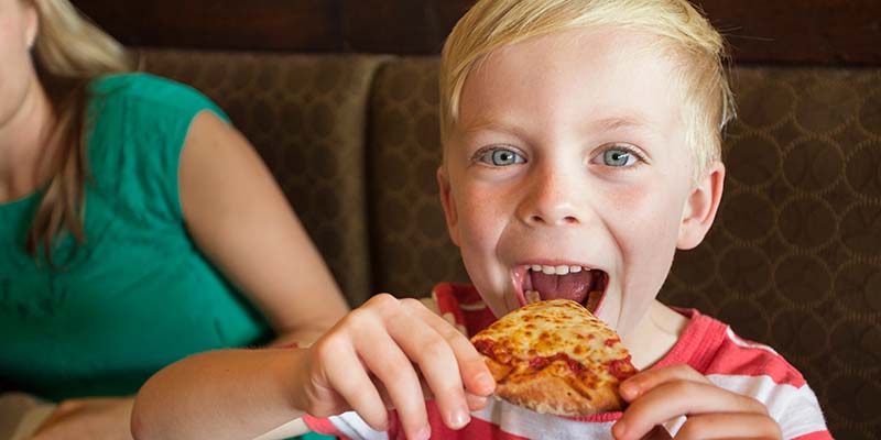 child eating pizza