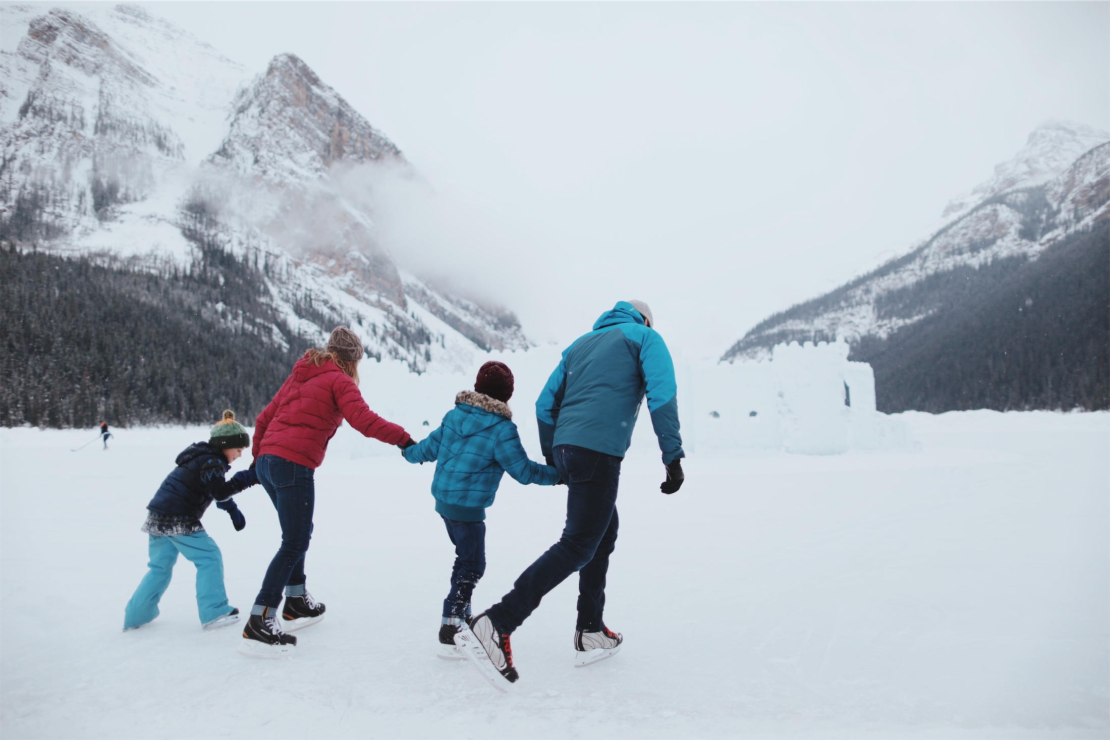 family skating on the lake
