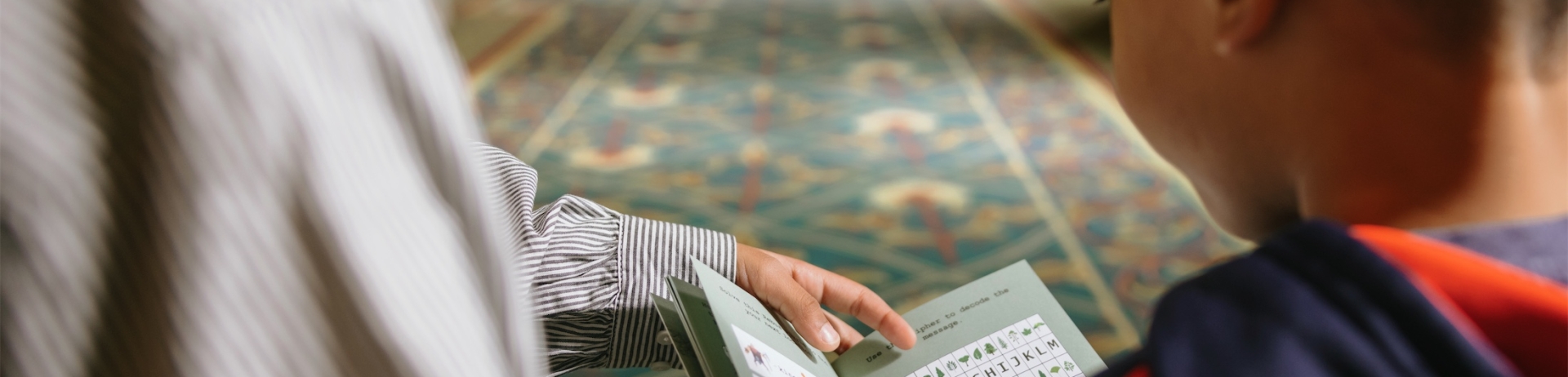 woman showing a child a hikers workbook