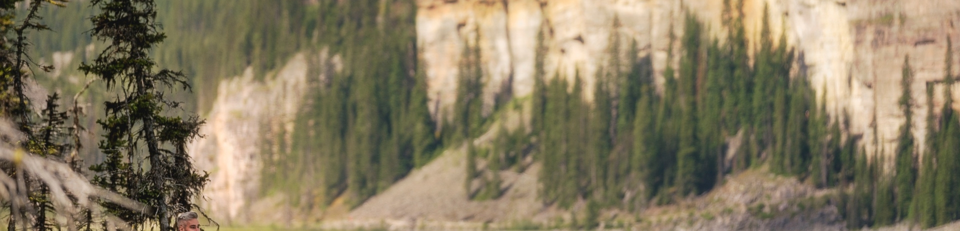 Two people embracing on the edge of Lake Louise