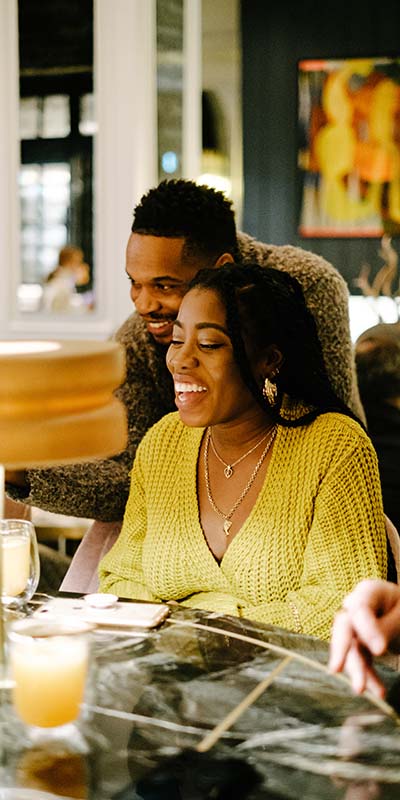 couple sits at a bar