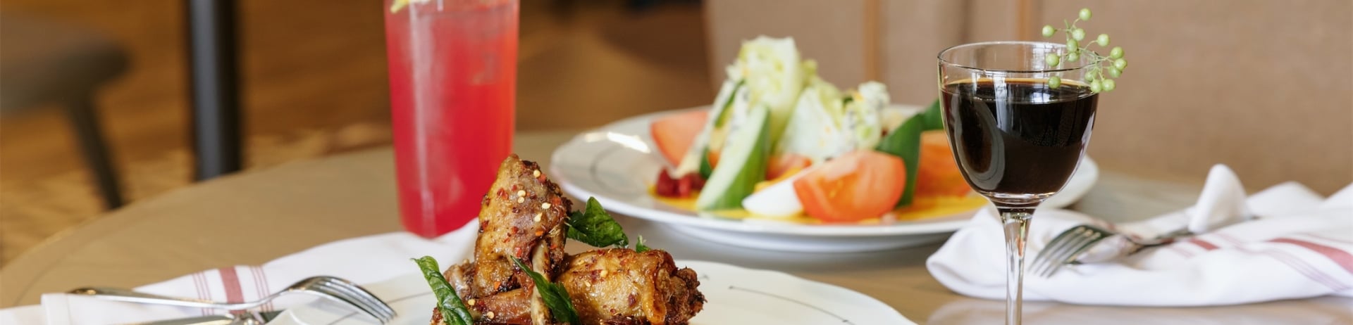 dining room table with a plate of meat and a plate of salad