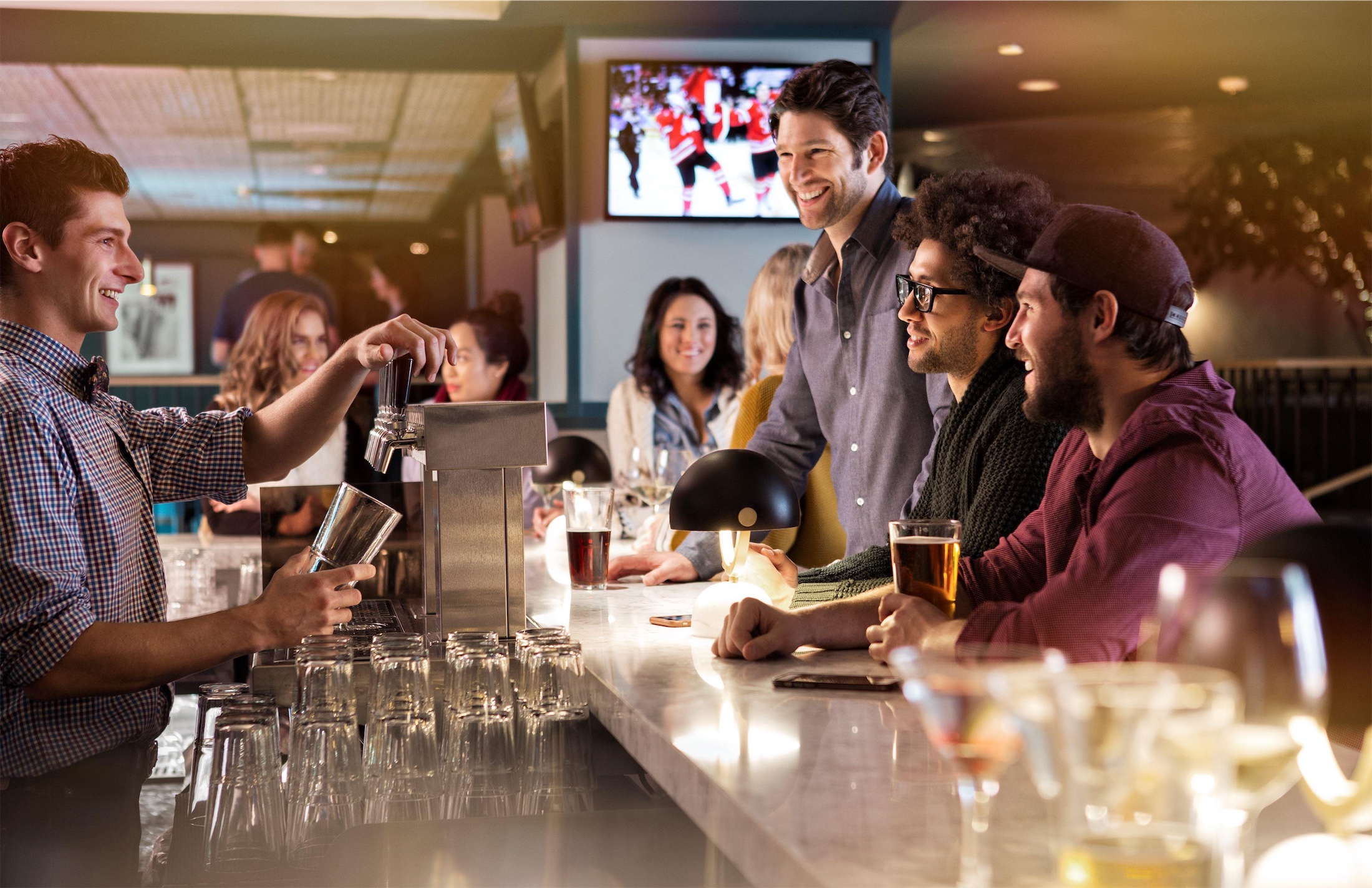 group of friends at the bar walking to the bartender