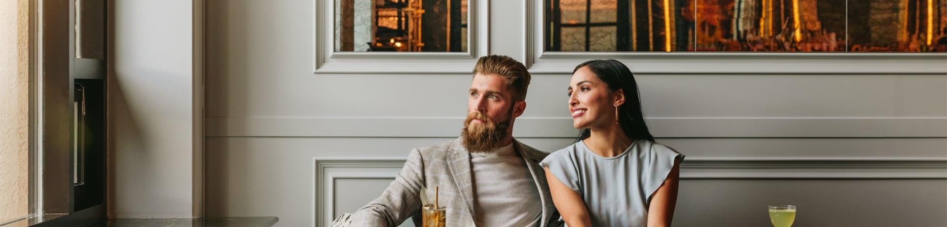 couple looking out the window while eating dinner