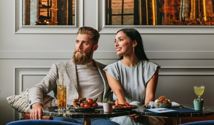 couple looking out the window while eating dinner