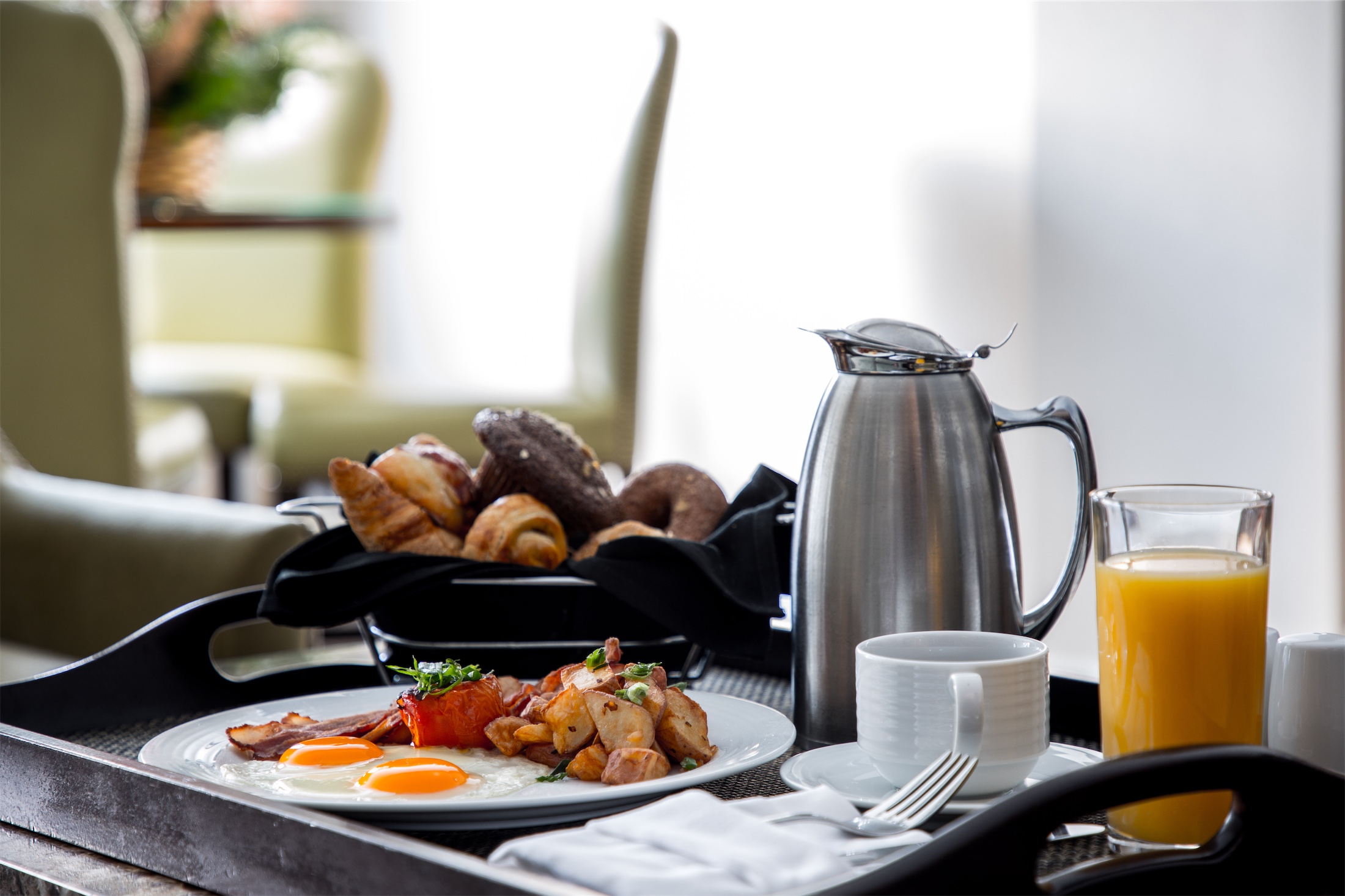 tray of breakfast with orange juice and coffee