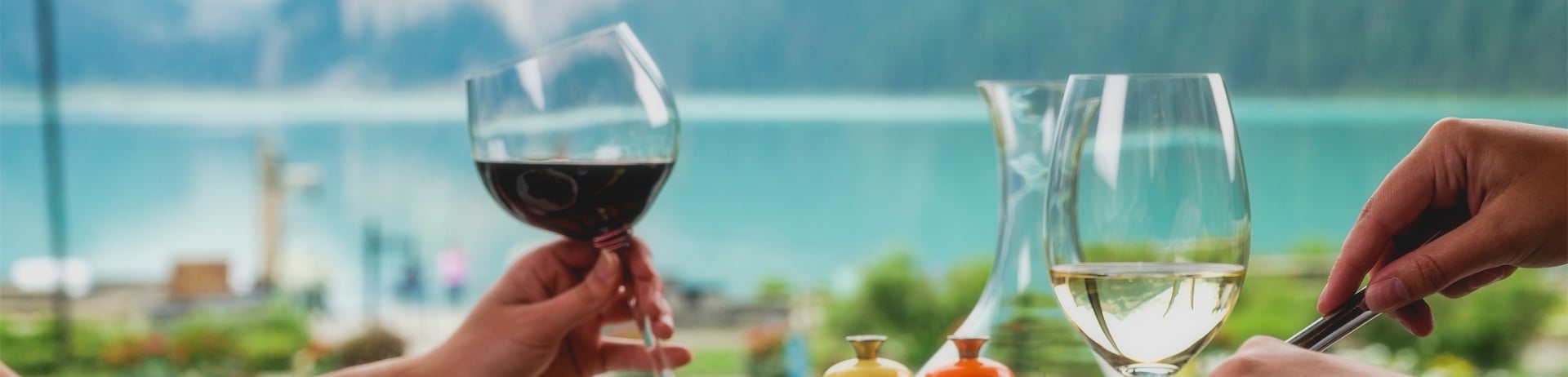 people eating next to large window that overlooks the lake