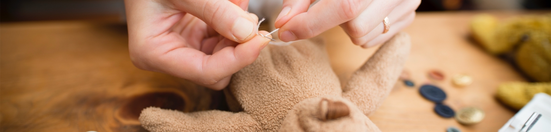 Hand to fix a stuffed toy bear