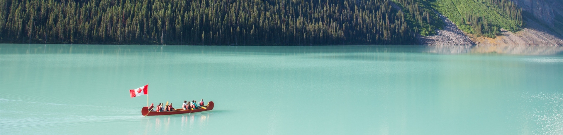 Scenic panoramic view of the turquoise waters of Lake Louise in Banff National Park, Canada during Canada Day.