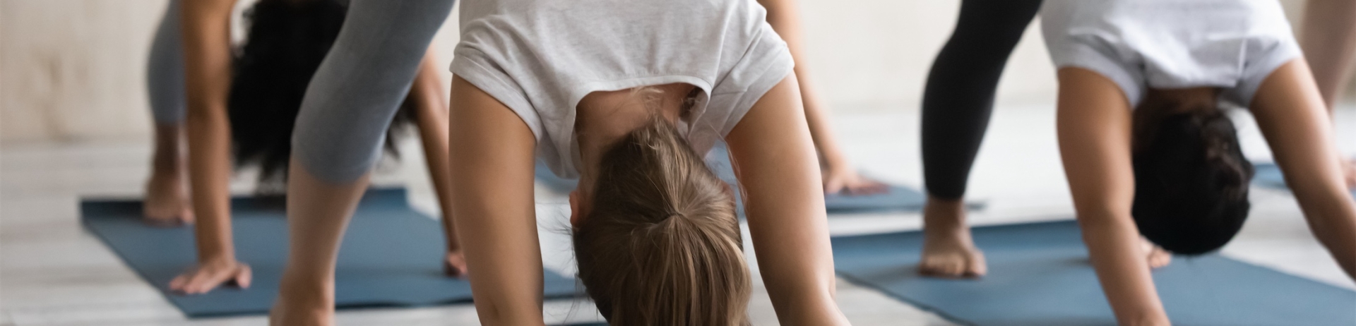 A yoga class doing Downward Facing Dog