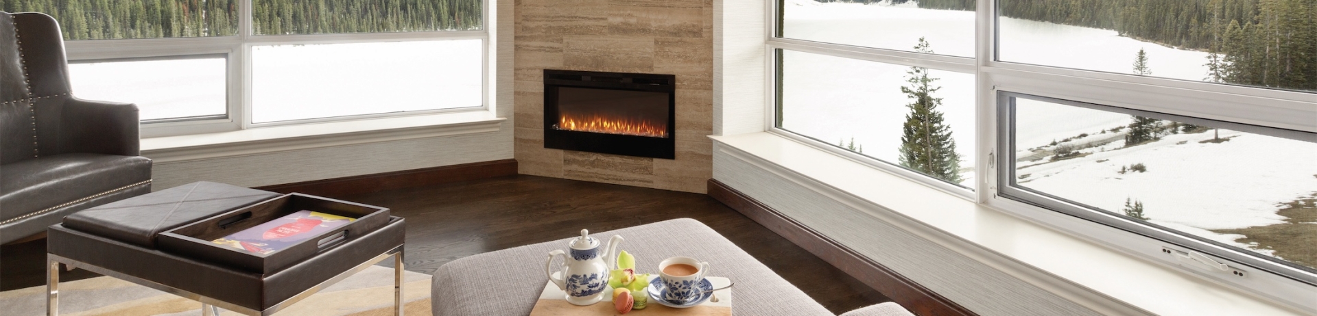 living room with a fireplace that overlooks the frozen lake