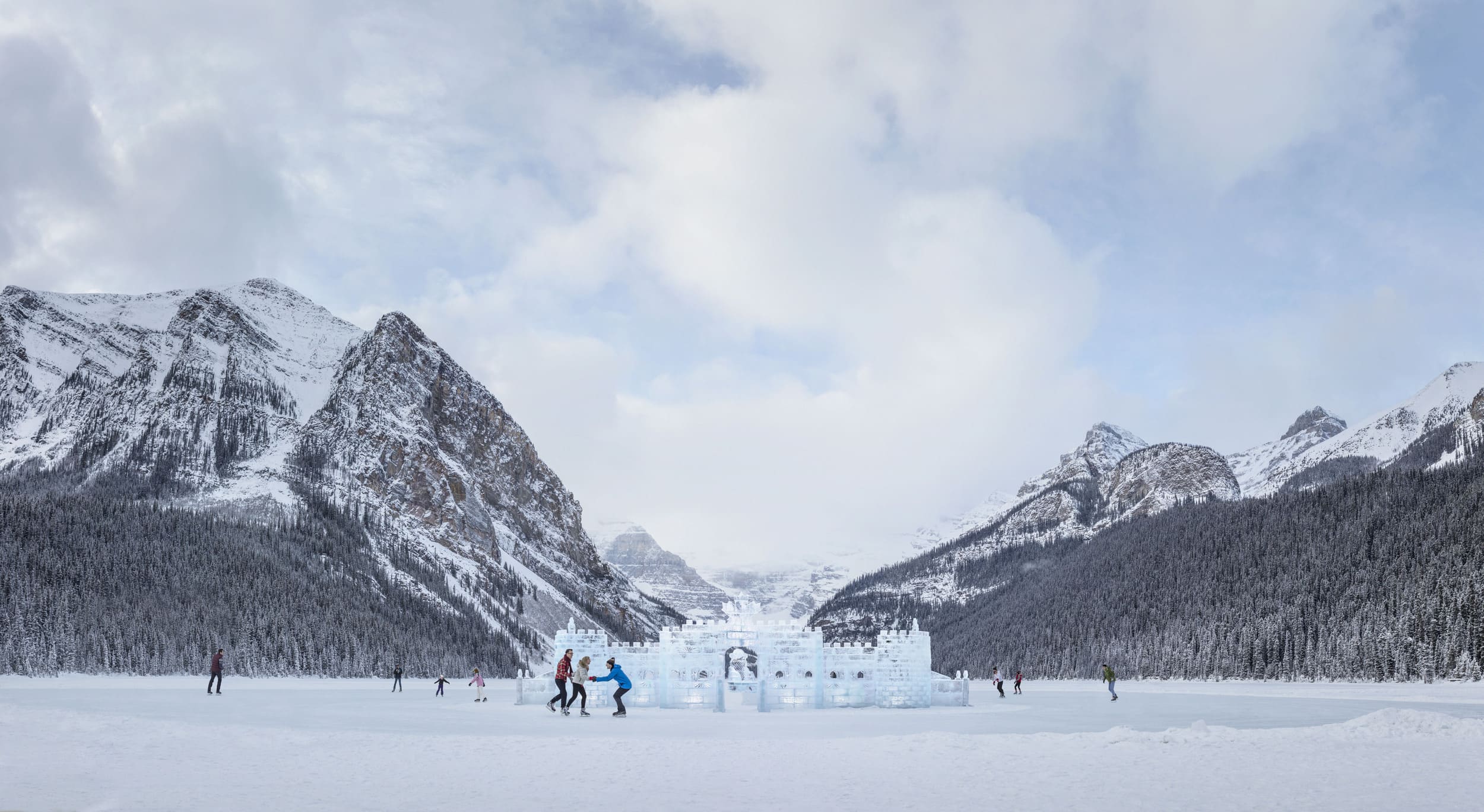 guests skating in front of a large ice sculpture