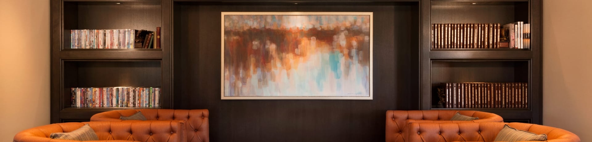 living room with built-in bookshelves and four chairs