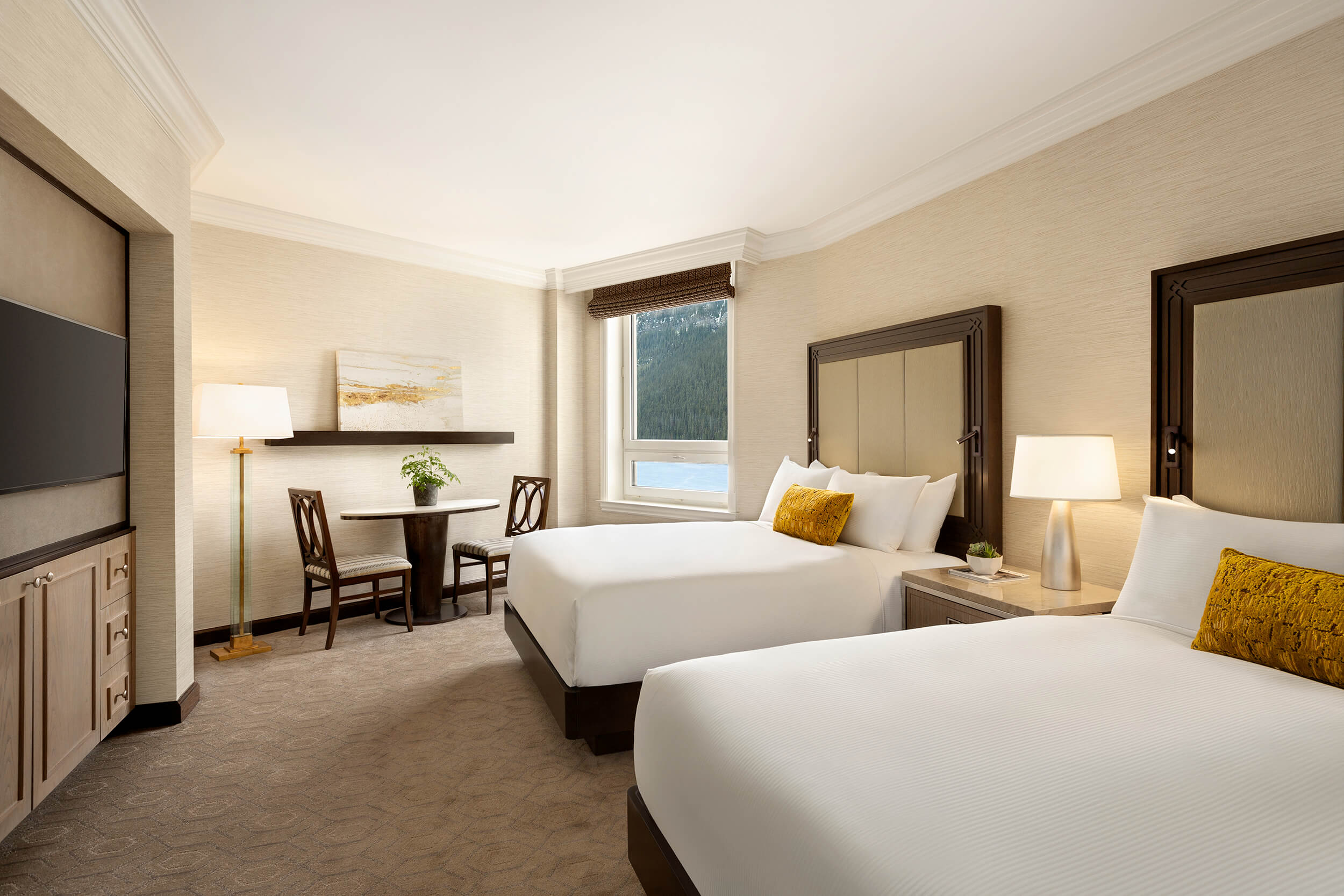 bedroom with two beds and small dining area