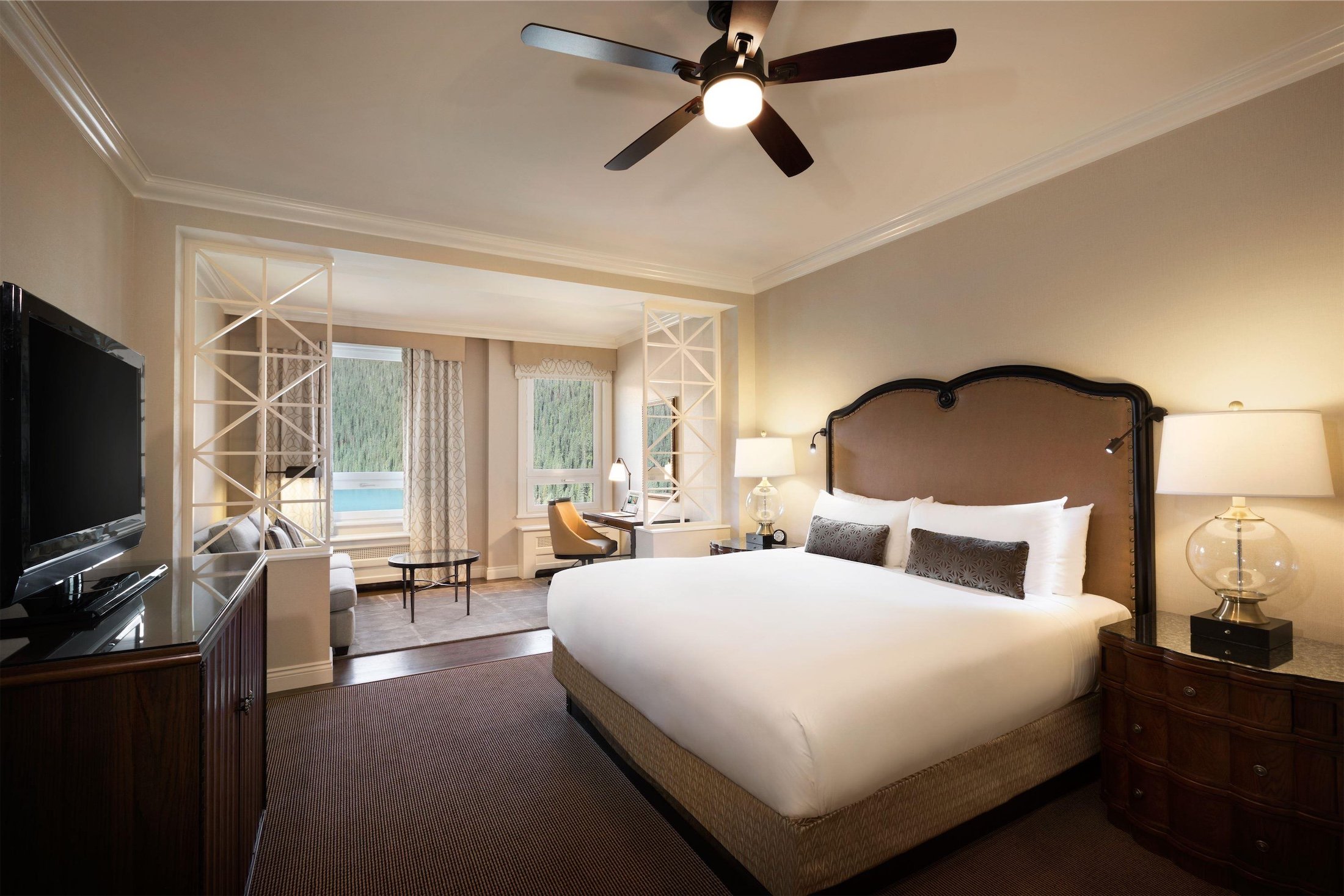 bedroom with alcove seating area and desk that overlooks the lake