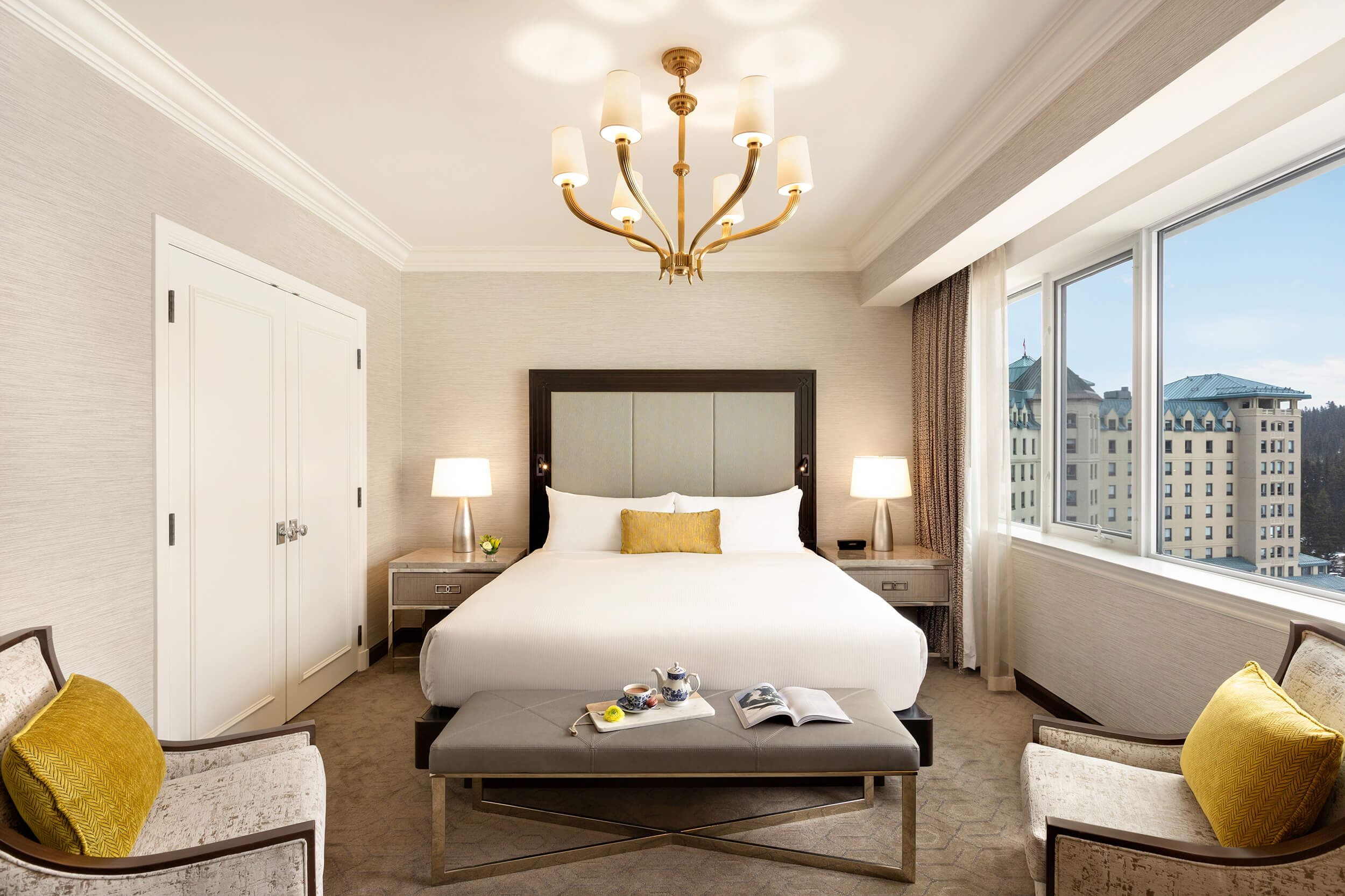 bedroom with two chairs and a bench