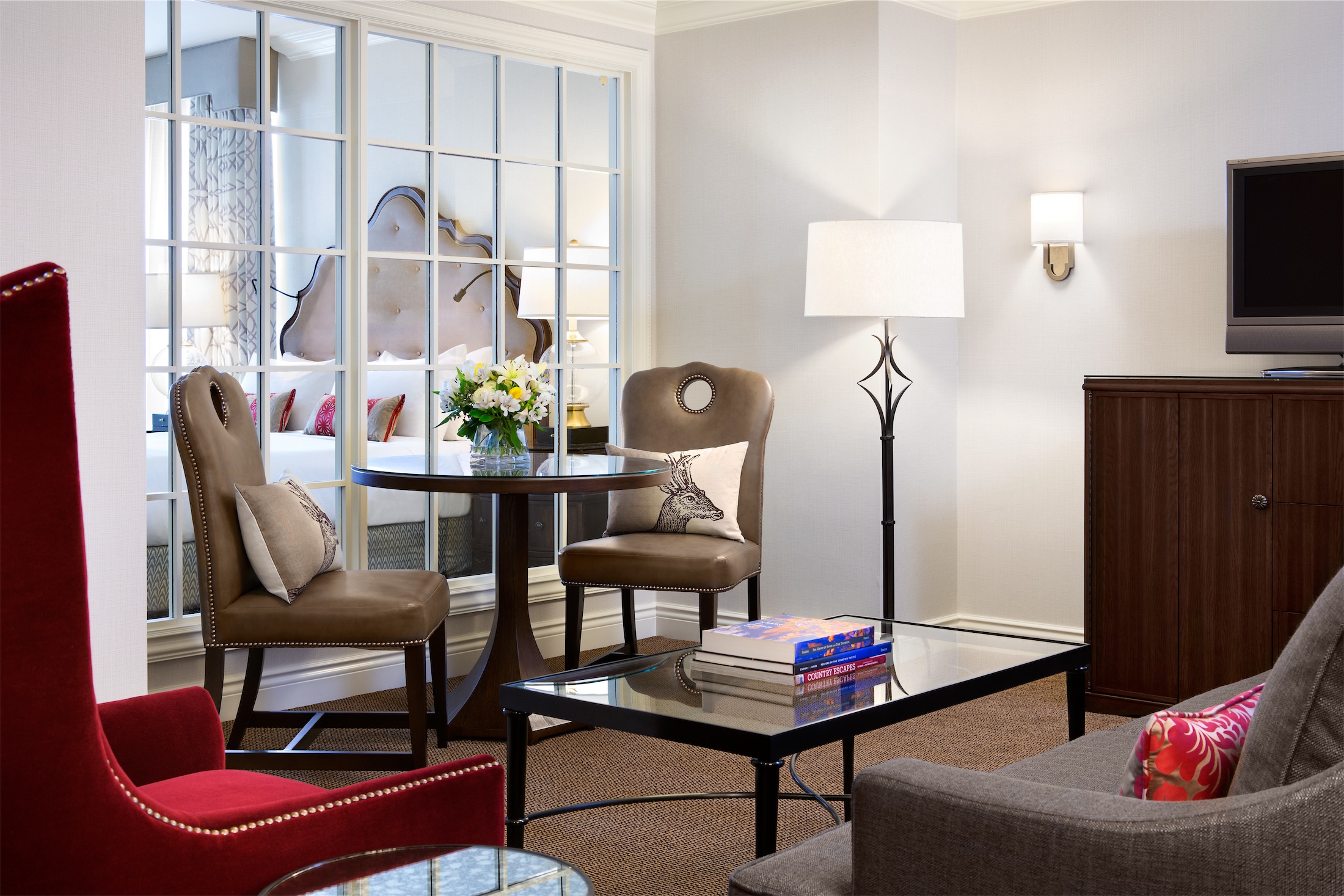 living room area with glass windows to view the bedroom
