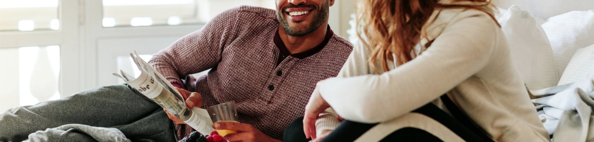 couple eating breakfast in bed