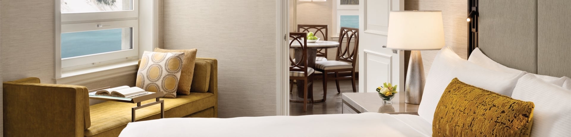 bedroom with chaise lounge and view of dining room