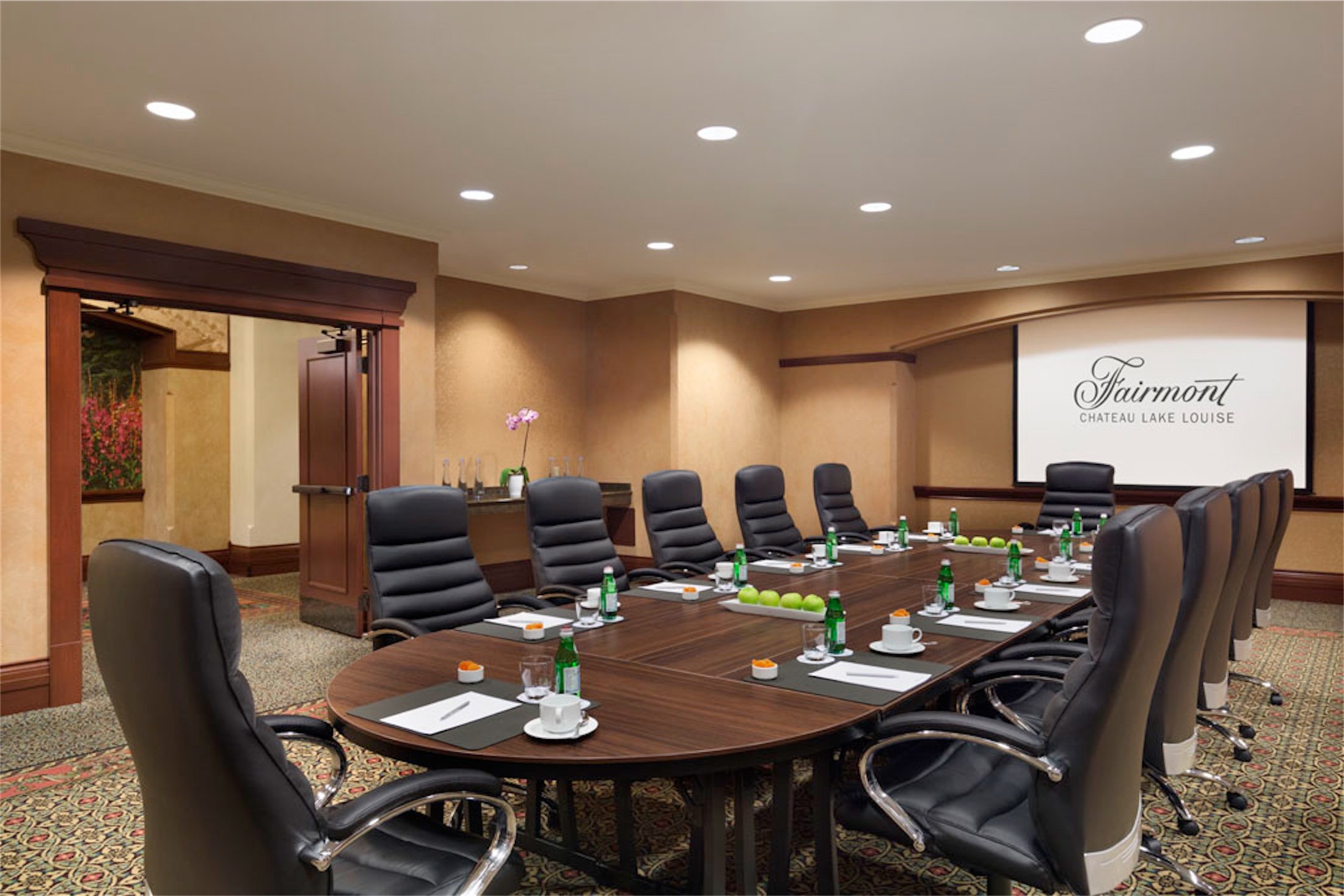 A meeting room with comfortable chairs and a long table
