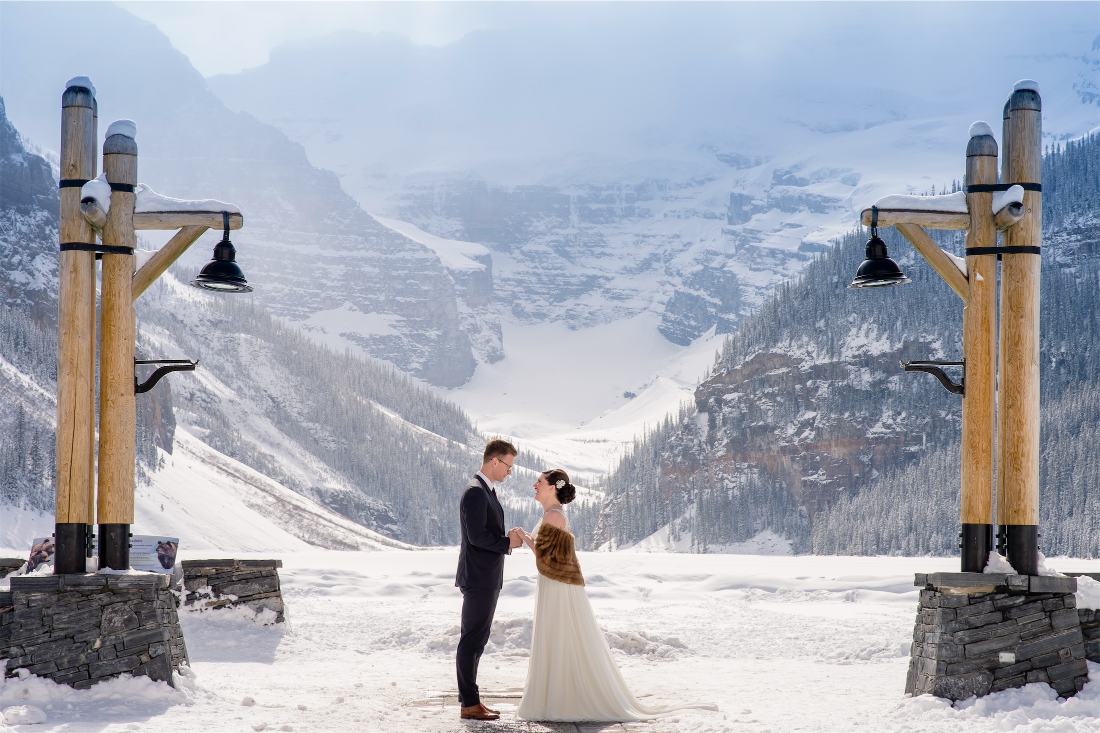 A couple getting married outside in the winter surrounded by mountains