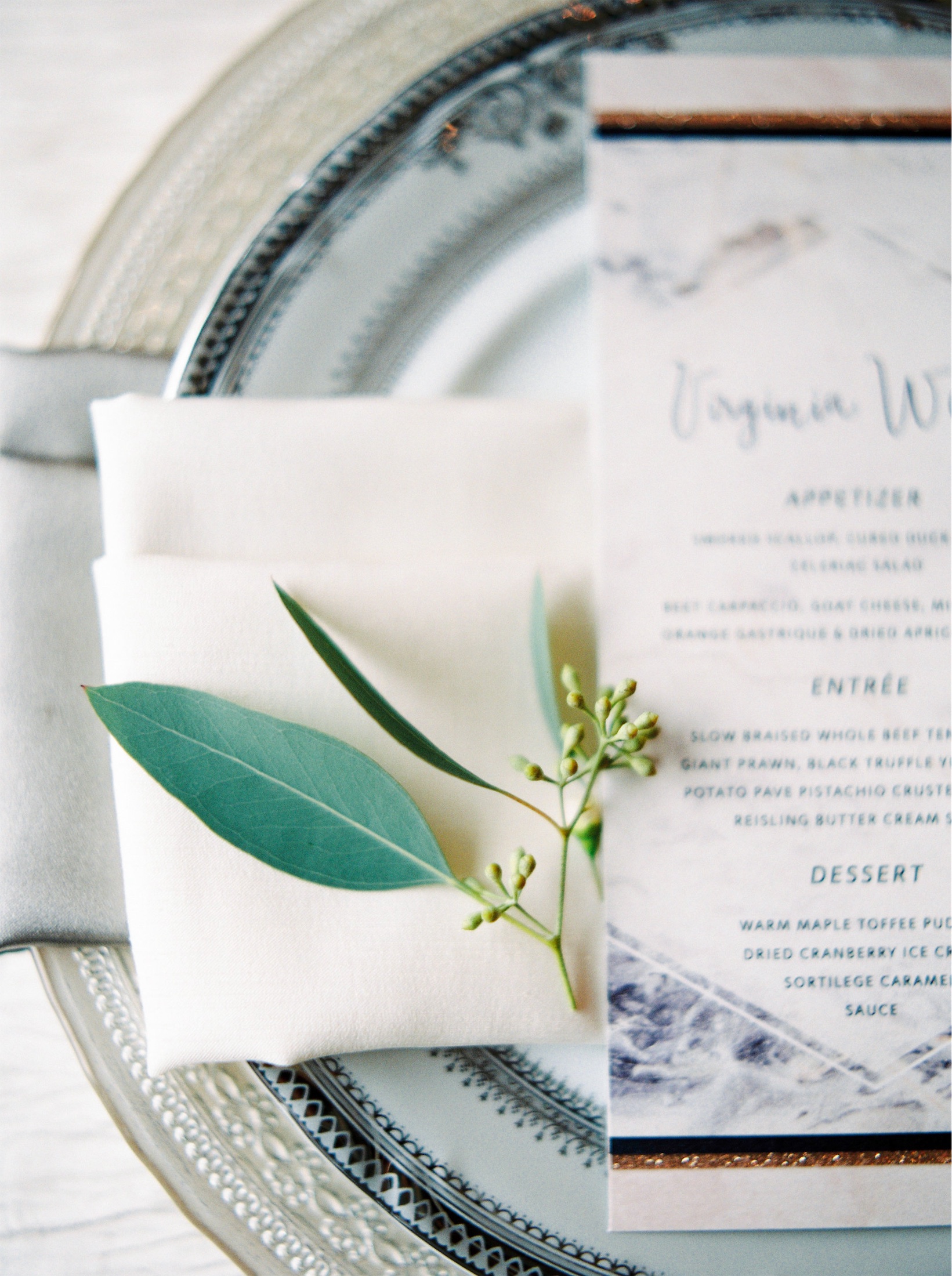 A delicate place setting with a printed dinner menu