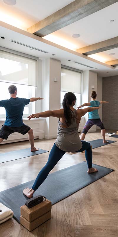 group of yoga attendees in warrior pose