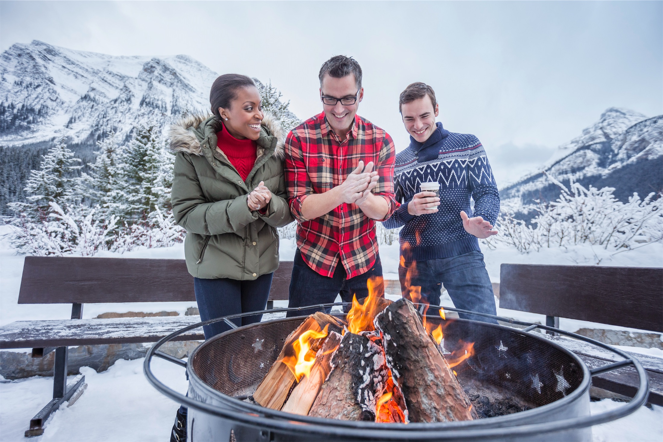 people gather around an outdoor firepit