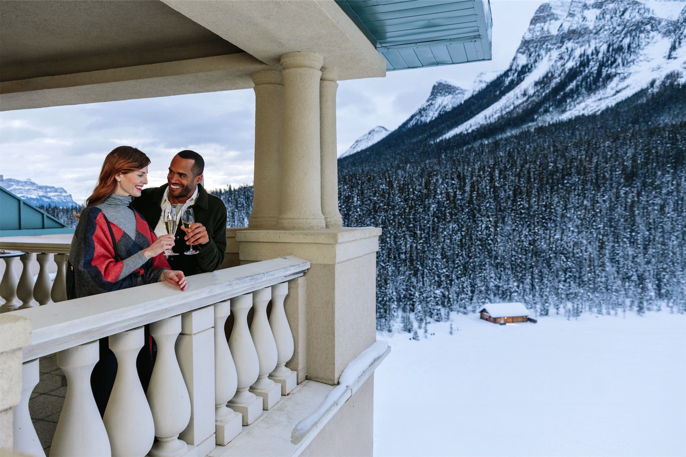 couple stands on balcony