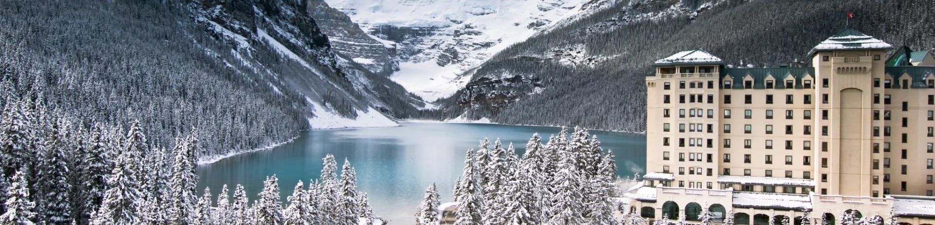 Chateau Lake Louise with lake and mountains 