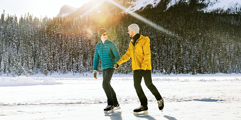 two people skating while holding hands