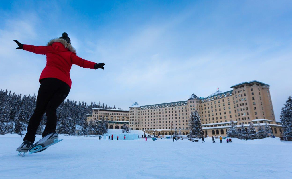 People skating on an outdoor rink outside Chateau Lake Louise