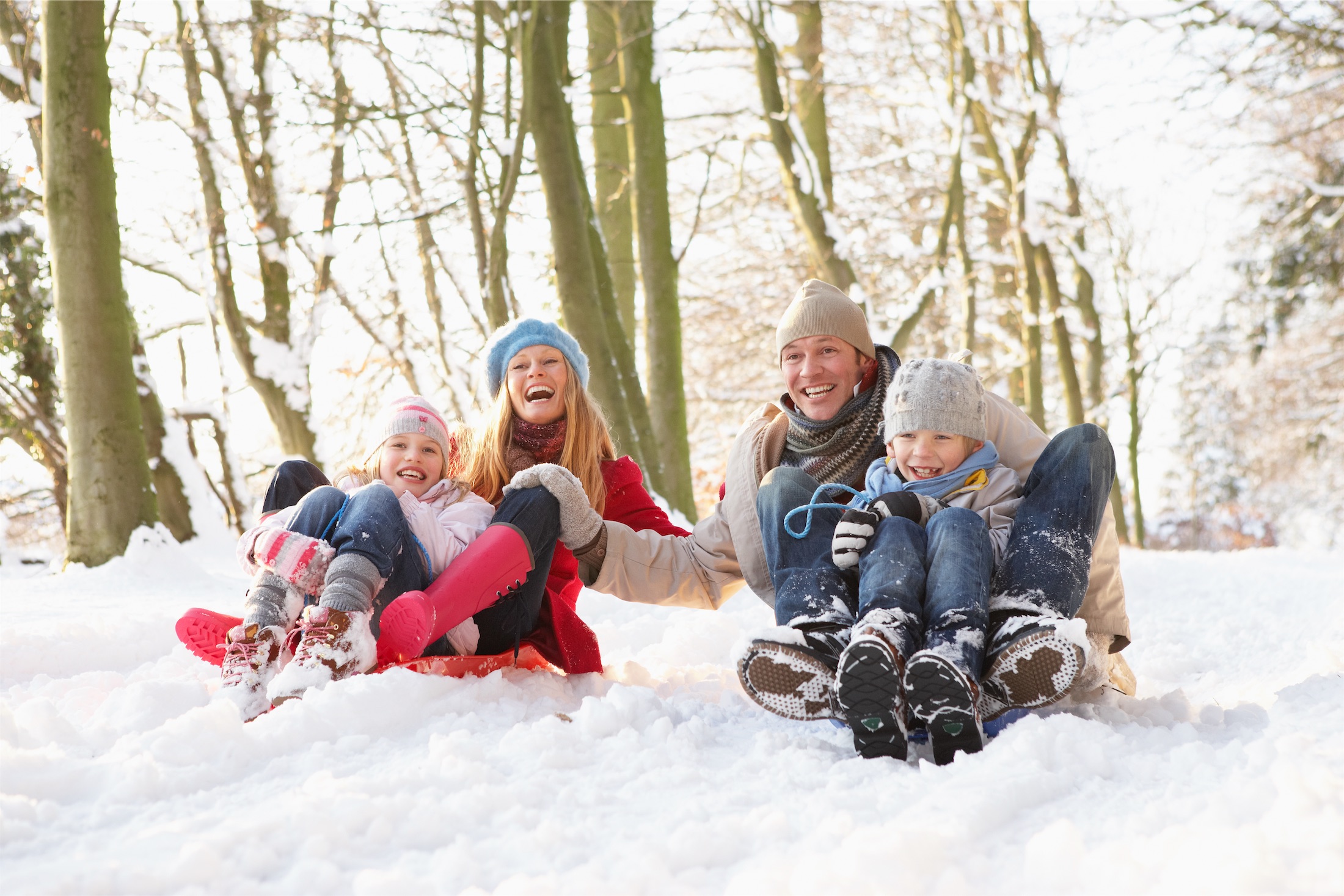 group of kids sit in snow