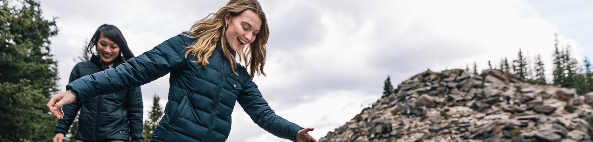 two women hiking by a lake