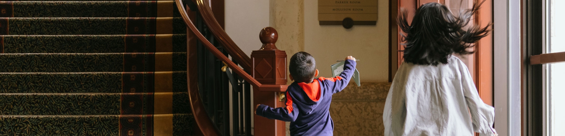 two children running down a corridor