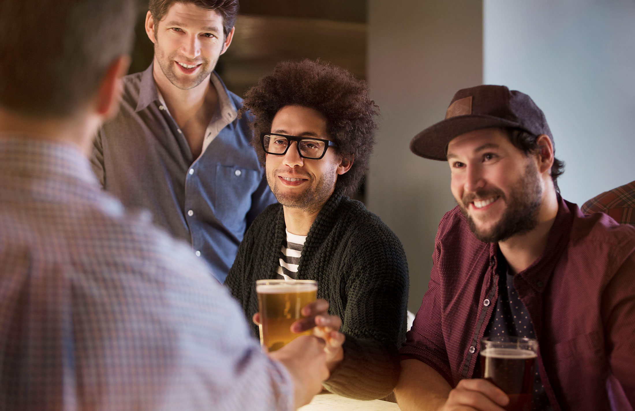 friends drinking in a bar together