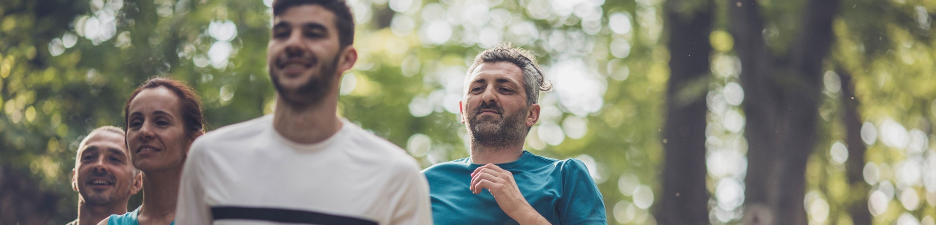 Group running outside through the trees