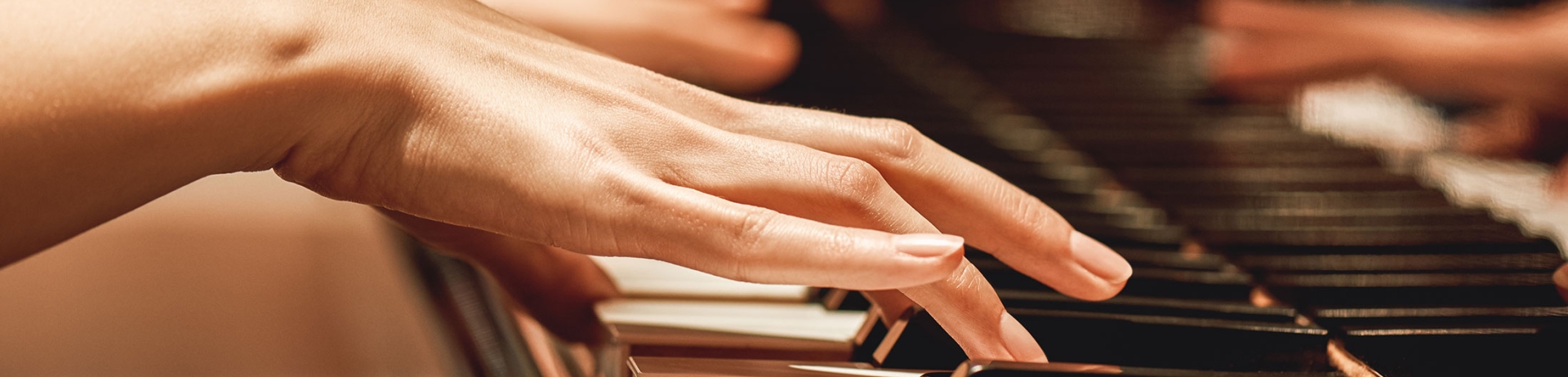 close up of ladies hands playing the piano