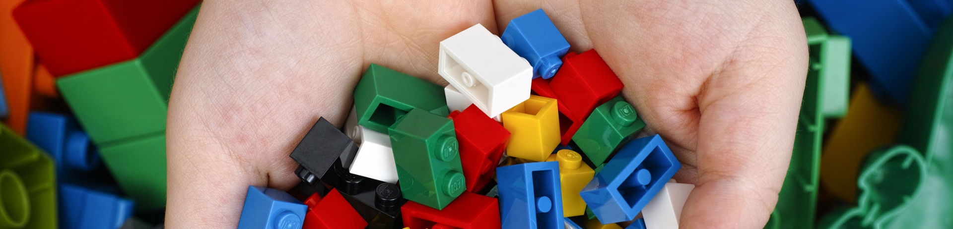 Childs hands holding small lego bricks
