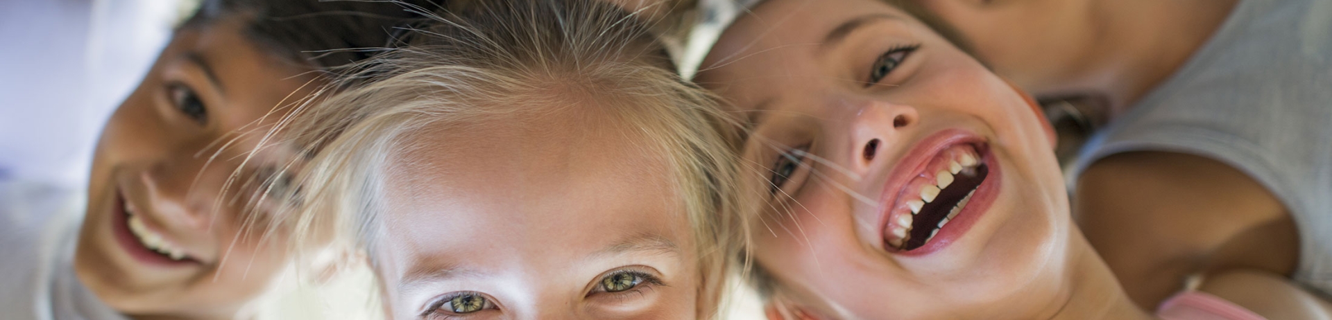 children hugging looking into circle