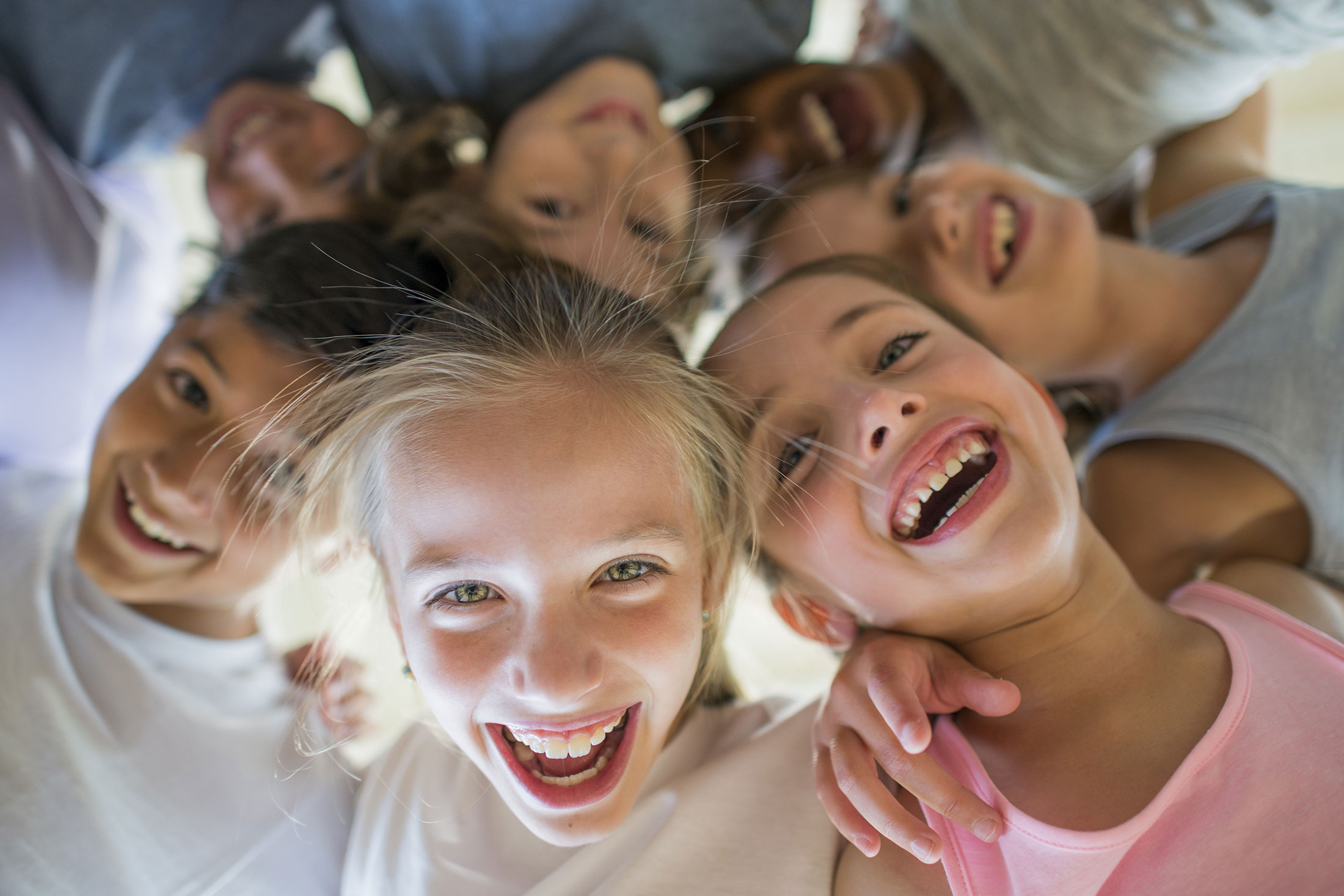 children hugging looking into circle