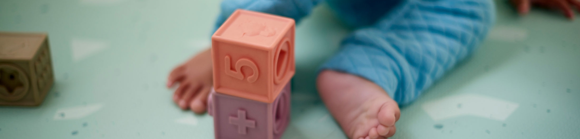 toddler feet with building blocks