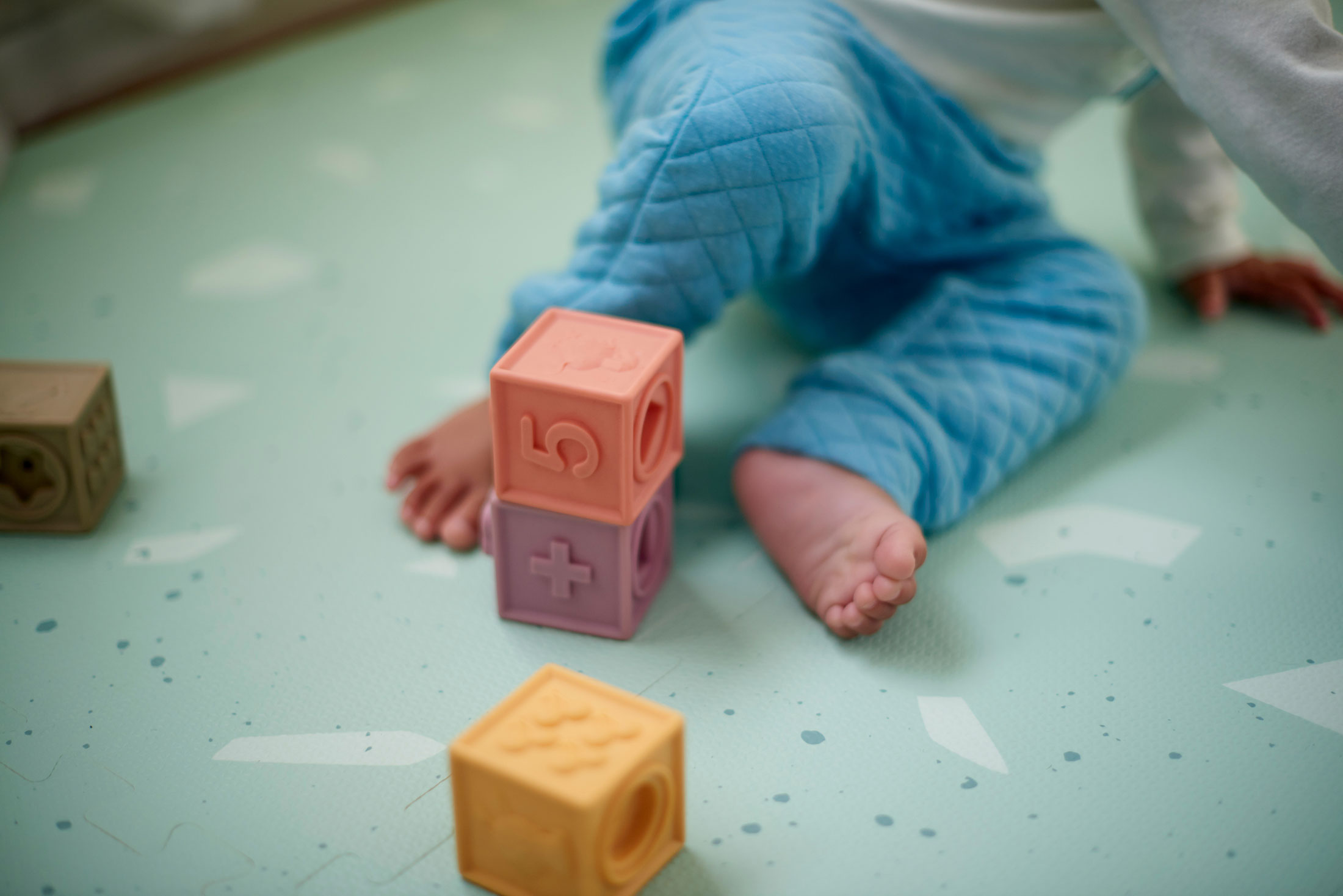 toddler feet with building blocks