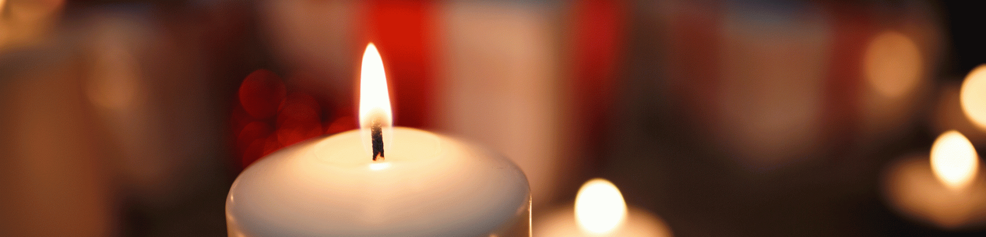 Group of white candles lit up